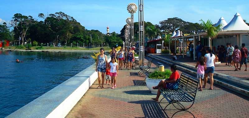 Families and tourists walking along Paseo del Mar boardwalk in Zamboanga City during daytime