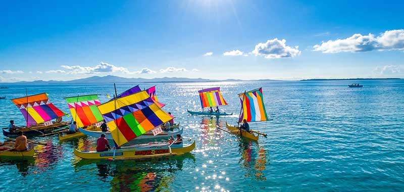 Colorful vinta boats racing during the Regatta de Zamboanga at Hermosa Festival